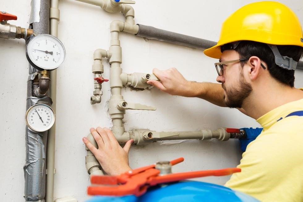 Engineer working on gas pipes Engineer working on gas pipes